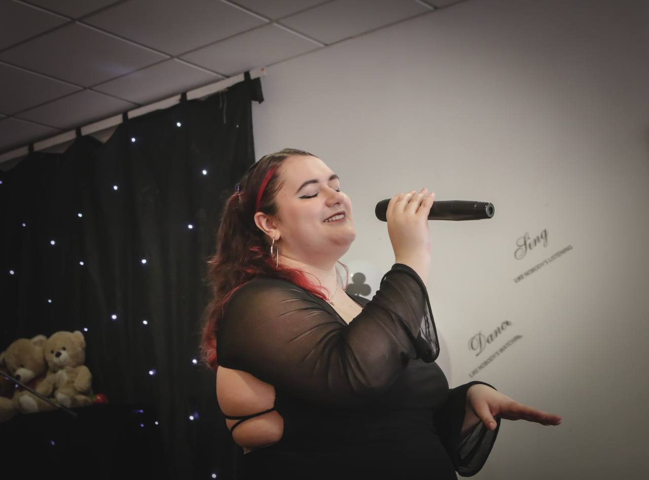 Yana singing at a live music event